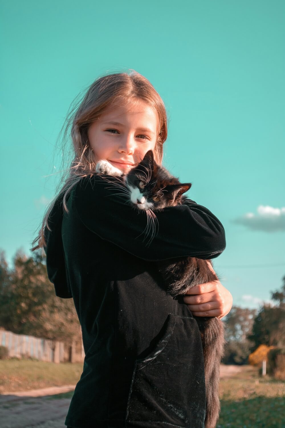 Child holding kitten
